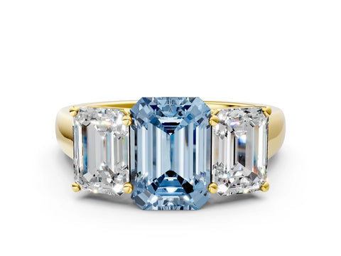 Yellow gold Fancy Blue Emerald Cut Three-Stone Diamond Ring with Prong Setting on a Classic Band