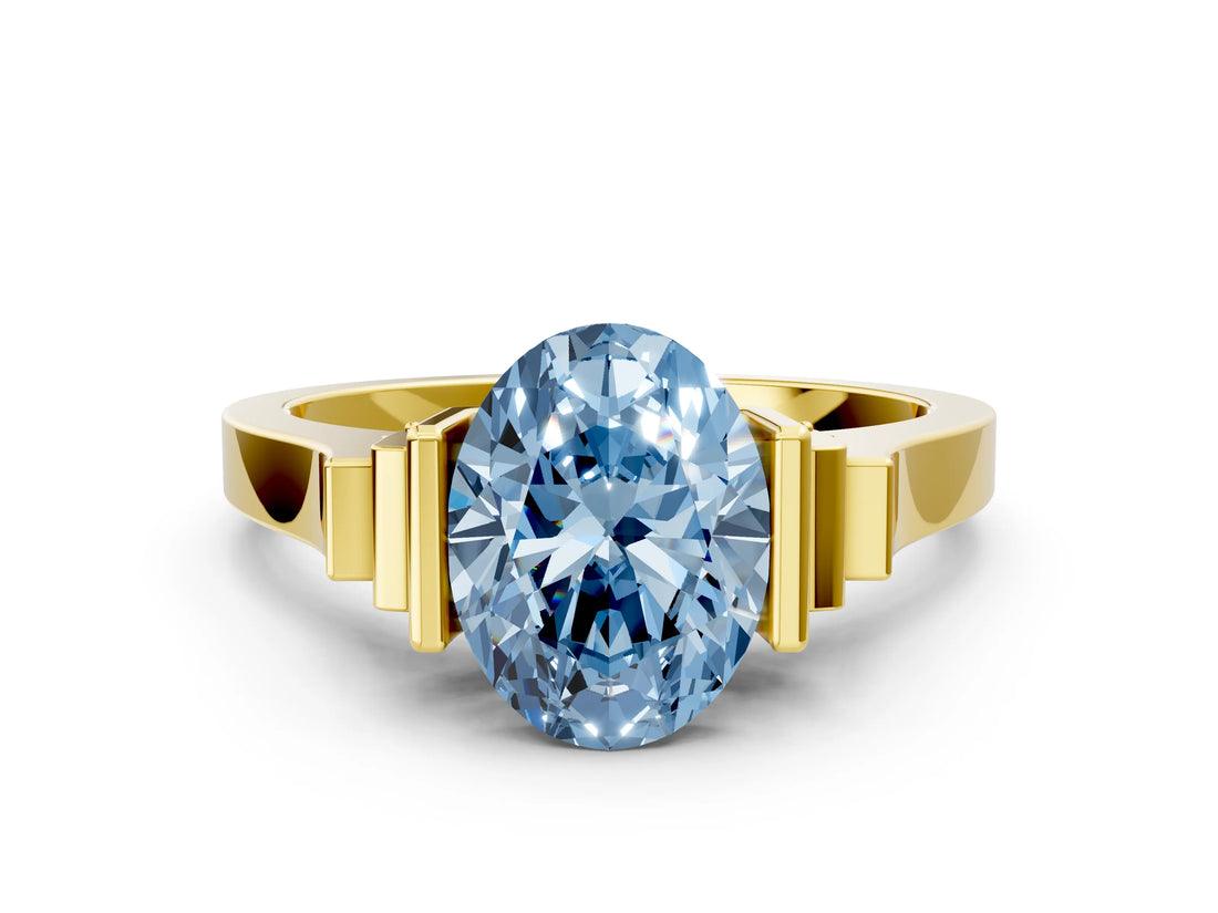 Yellow gold Fancy Blue Oval Cut Brilliant Solitaire Diamond Ring with Channel Set Band and Bar Prong Setting