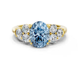 Yellow gold Fancy Blue Oval  Cut Diamond Cluster Ring with Round Accent Stones and Prong Setting on a Classic Band_49