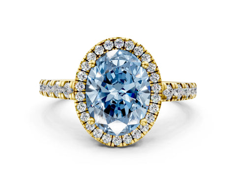 Yellow gold Fancy Blue Oval Cut Diamond Halo Ring with Pavé Band and Four-Prong Setting