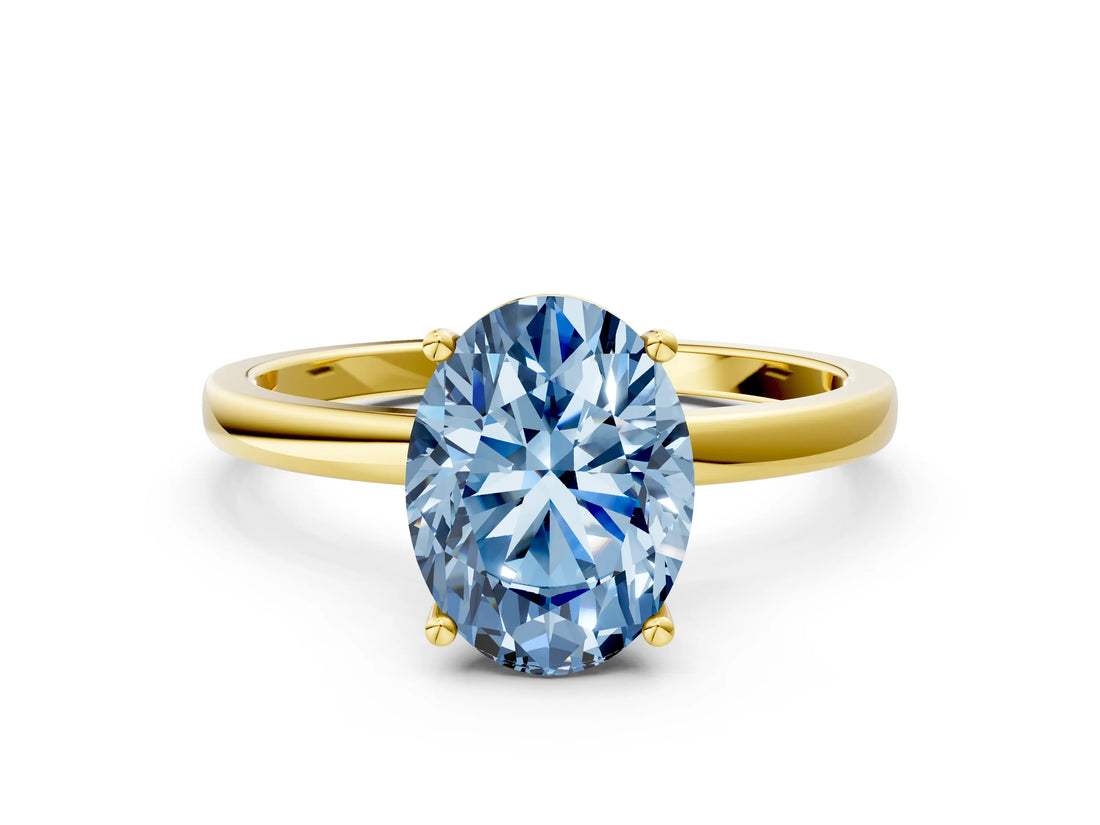 Yellow gold Fancy Blue Oval Cut Diamond Solitaire Ring with Classic Band and Four-Prong Setting
