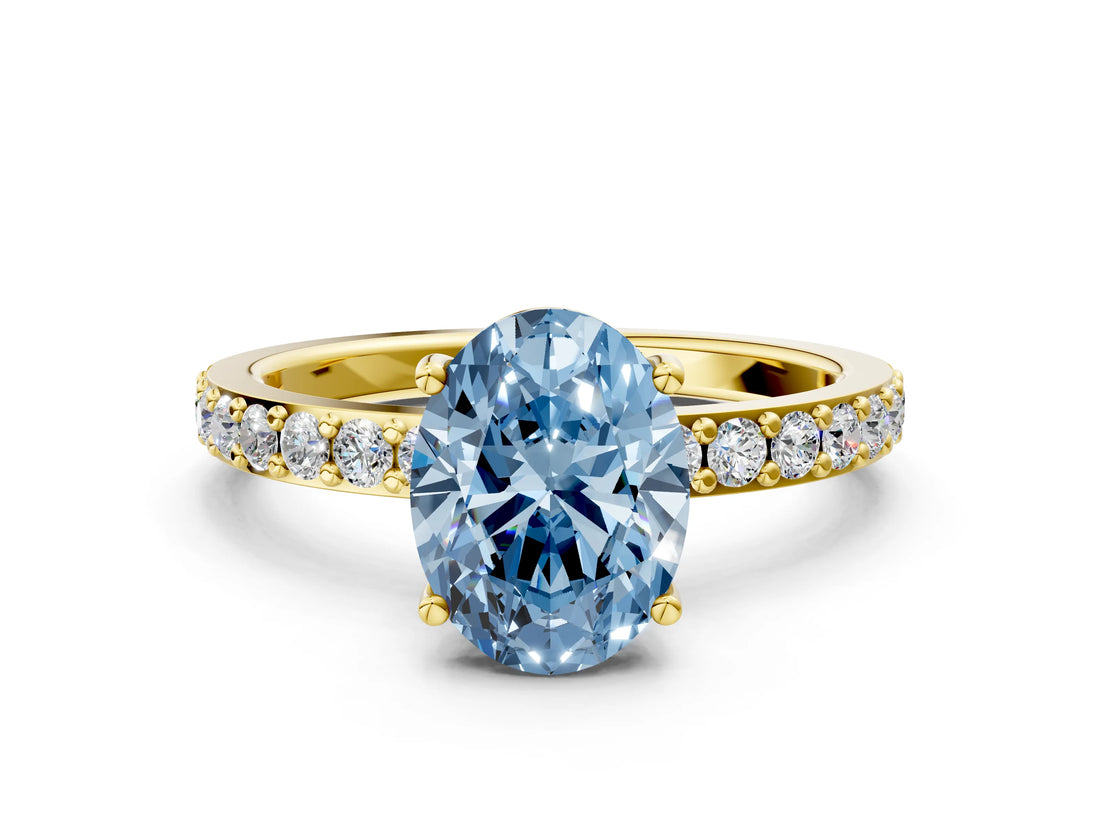 Yellow gold Fancy Blue Oval  Cut Diamond Solitaire with Pave Band and Four-Prong Setting