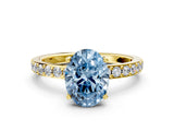 Yellow gold Fancy Blue Oval  Cut Diamond Solitaire with Pave Band and Four-Prong Setting