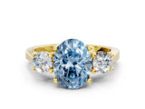 Yellow gold Fancy Blue Oval Cut Diamond Three-Stone Engagement Ring with Prong Setting and Pavé Band