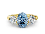 Yellow gold Fancy Blue Oval Cut Diamond Three-Stone Ring with Prong Setting and Pavé Band