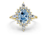 Yellow gold Fancy Blue Oval Cut Halo Diamond Cluster Ring with Marquise and Round Stones on a White Gold Band with Prong Setting