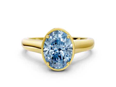 Yellow gold Fancy Blue Oval Cut Solitaire Diamond Engagement Ring with Four-Prong Setting and Tapered Band