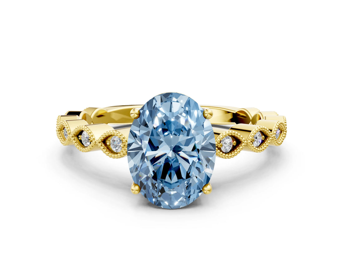 Yellow gold Fancy Blue Oval Cut Solitaire Diamond Ring with Infinity Twist Band and Four-Prong Setting