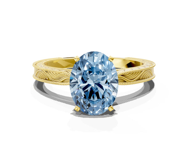 Yellow gold Fancy Blue Oval Cut Solitaire Milgrain Engraved Band with Four-Prong Setting