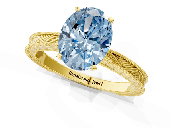 Yellow gold Fancy Blue Oval Cut Solitaire Milgrain Engraved Band with Four-Prong Setting