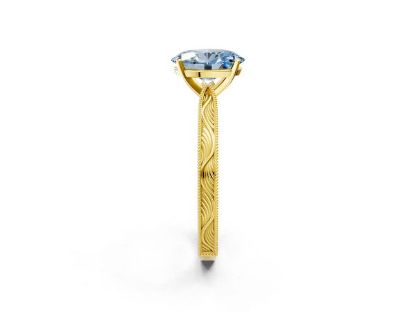Yellow gold Fancy Blue Oval Cut Solitaire Milgrain Engraved Band with Four-Prong Setting