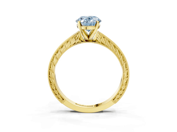 Yellow gold Fancy Blue Oval Cut Solitaire Milgrain Engraved Band with Four-Prong Setting