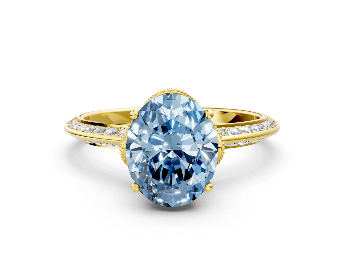 Yellow gold Fancy Blue Oval Cut Solitaire Split Shank Pave Diamond Engagement Ring with Four-Prong Setting