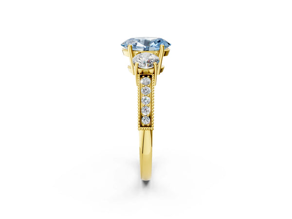 Yellow gold Fancy Blue Oval Cut Three-Stone Diamond Ring with Pavé Band and Four-Prong Setting