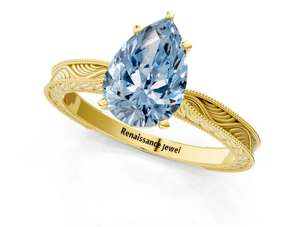 Yellow gold Fancy Blue Pear Cut Solitaire Milgrain Engraved Band with Four-Prong Setting