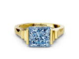 Yellow gold Fancy Blue Princess Cut Brilliant Solitaire Diamond Ring with Channel Set Band and Bar Prong Setting