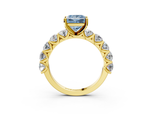 Yellow gold Fancy Blue Princess Cut Diamond Prong Setting with Side Stones on a Pave Band