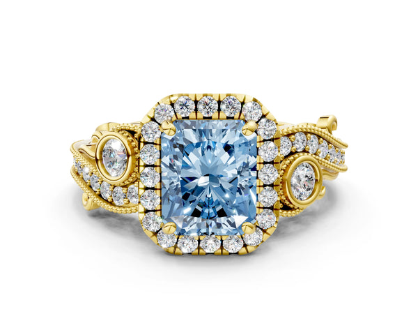 Yellow gold Fancy Blue Radiant Cut Diamond Halo Ring with Milgrain Pavé Band and Four-Prong Setting