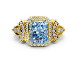 Yellow gold Fancy Blue Radiant Cut Halo Diamond Split Shank Engagement Ring with Four-Prong Setting