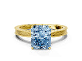 Yellow gold Fancy Blue Radiant Cut Solitaire Milgrain Engraved Band with Four-Prong Setting