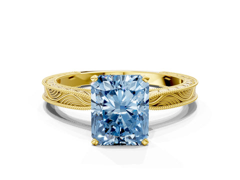 Yellow gold Fancy Blue Radiant Cut Solitaire Milgrain Engraved Band with Four-Prong Setting