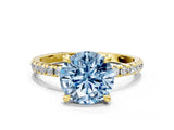 Yellow gold Fancy Blue Round Cut Diamond Brilliant Solitaire Ring with Pavé Band and Four-Prong Setting