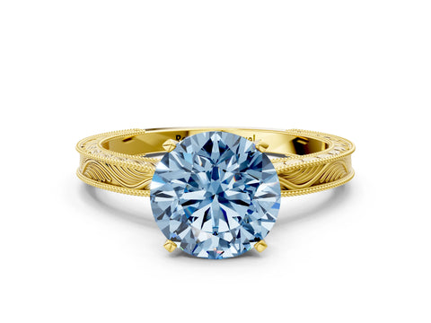 Yellow gold Fancy Blue Round Cut Solitaire Milgrain Engraved Band with Four-Prong Setting