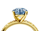 Yellow gold Fancy Blue Round  Solitaire Diamond Engagement Ring with XO Engraved Band and Four-Prong Setting