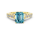 Yellow gold Fancy White Emerald Cut Blue Topaz Solitaire Ring with Cathedral Setting and Pavé Band