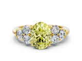 Yellow gold Fancy Yellow Oval  Cut Diamond Cluster Ring with Round Accent Stones and Prong Setting on a Classic Band_48