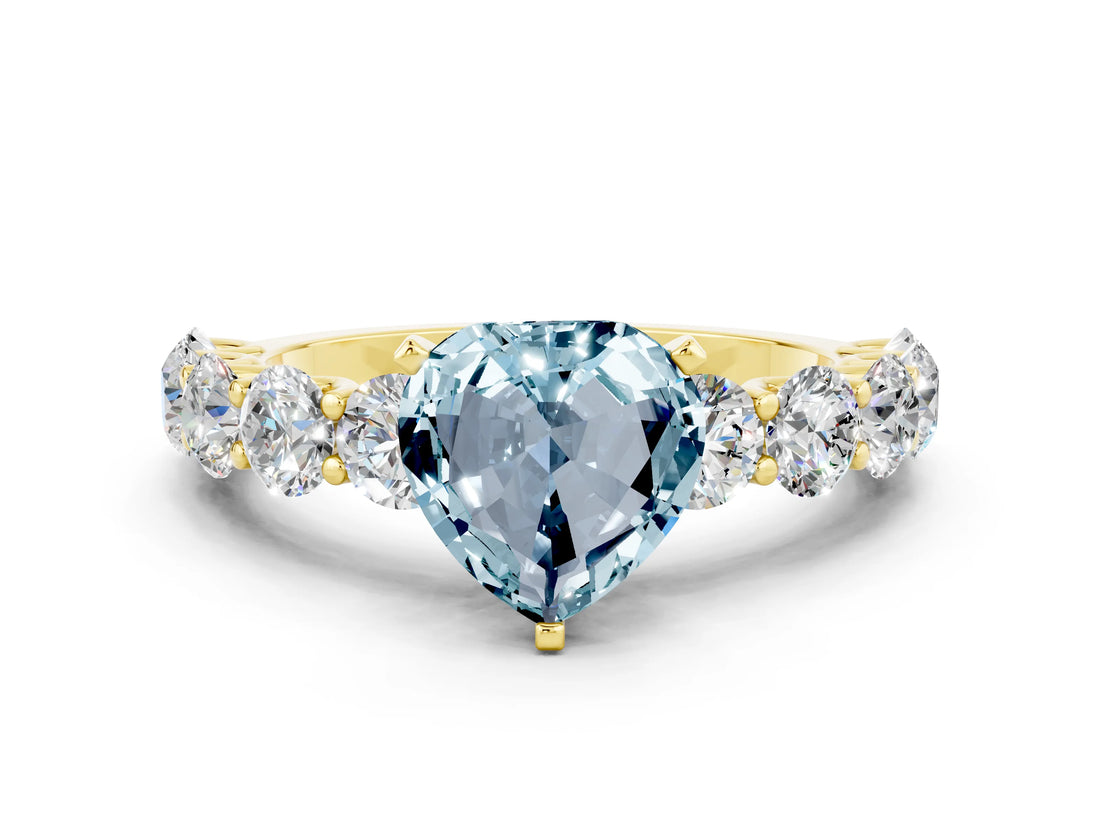 Yellow gold Heart Cut Aquamarine Prong Setting with Side Stones on a Pave Band