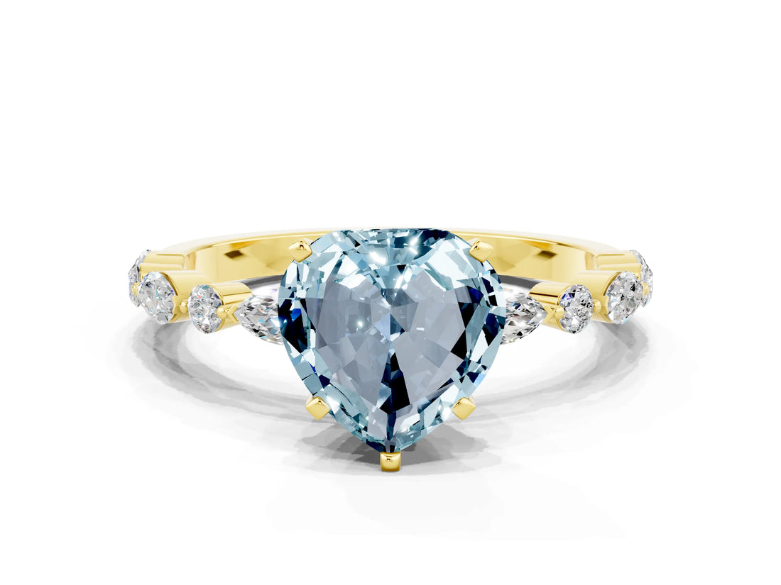 Yellow gold Heart Cut Aquamarine Solitaire with Side Stones on a Pavé Band and Four-Prong Setting