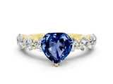 Yellow gold Heart Cut Blue Sapphire Prong Setting with Side Stones on a Pave Band