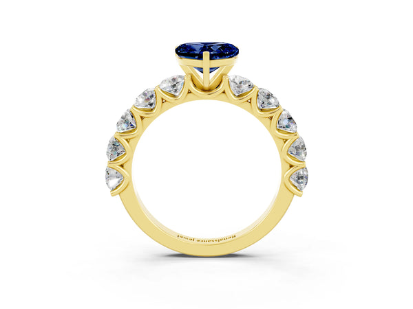 Yellow gold Heart Cut Blue Sapphire Prong Setting with Side Stones on a Pave Band