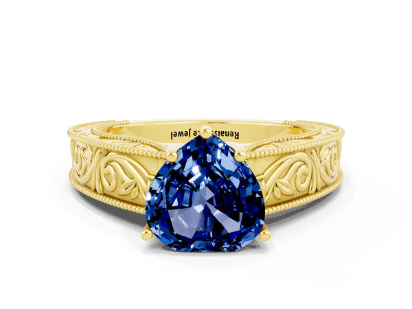 Yellow gold Heart Cut Blue Sapphire Solitaire Ring with Engraved Band and Four-Prong Setting