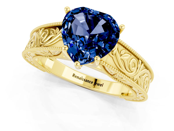 Yellow gold Heart Cut Blue Sapphire Solitaire Ring with Engraved Band and Four-Prong Setting