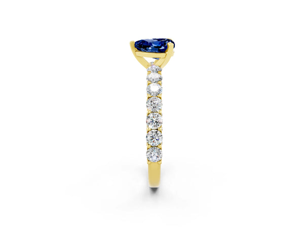 Yellow gold Heart Cut Blue Sapphire Solitaire Ring with Shared Prong Pavé Band and Four-Prong Setting