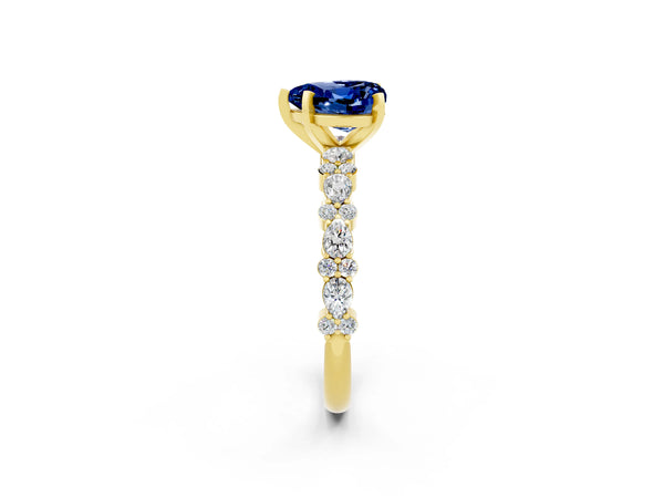 Yellow gold Heart Cut Blue Sapphire Side Stone Solitaire Ring with Round  and Four-Prong Setting