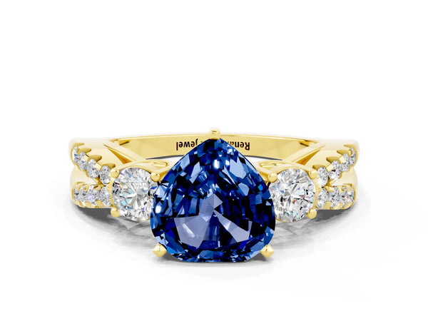 Yellow gold Heart Cut Blue Sapphire Three-Stone Ring with Pavé Split Shank and Four-Prong Setting
