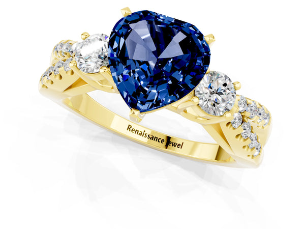 Yellow gold Heart Cut Blue Sapphire Three-Stone Ring with Pavé Split Shank and Four-Prong Setting
