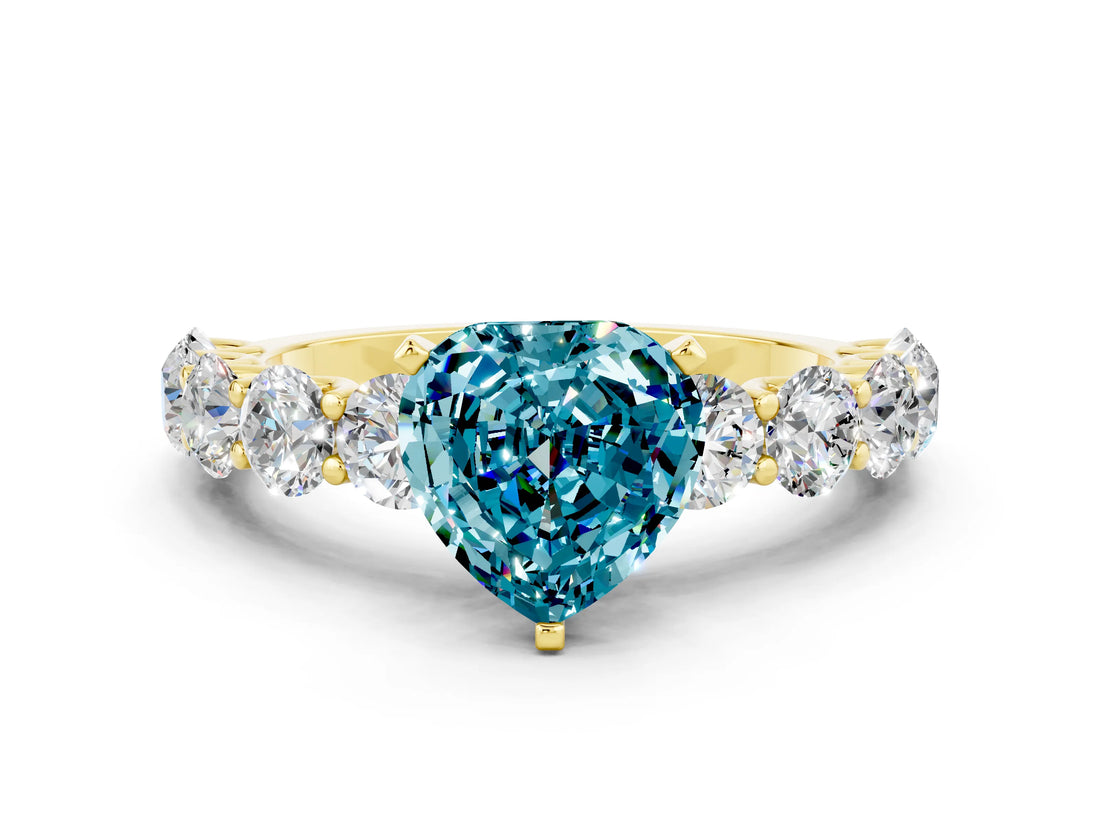 Yellow gold Heart Cut Blue Topaz Prong Setting with Side Stones on a Pave Band