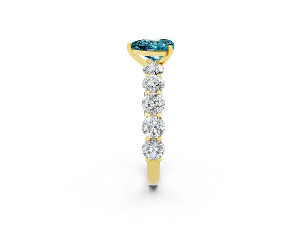 Yellow gold Heart Cut Blue Topaz Prong Setting with Side Stones on a Pave Band