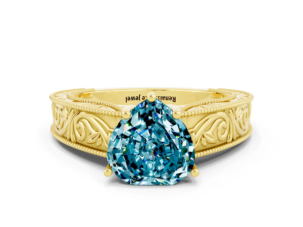 Yellow gold Heart Cut Blue Topaz Solitaire Ring with Engraved Band and Four-Prong Setting