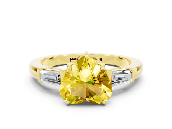 Yellow gold Heart Cut Yellow Sapphire Three-Stone Ring with Tapered Baguette Side Stones and Prong Setting