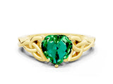 Yellow gold Heart Cut Emerald Solitaire Engagement Ring with Celtic Knot Band and Four-Prong Setting