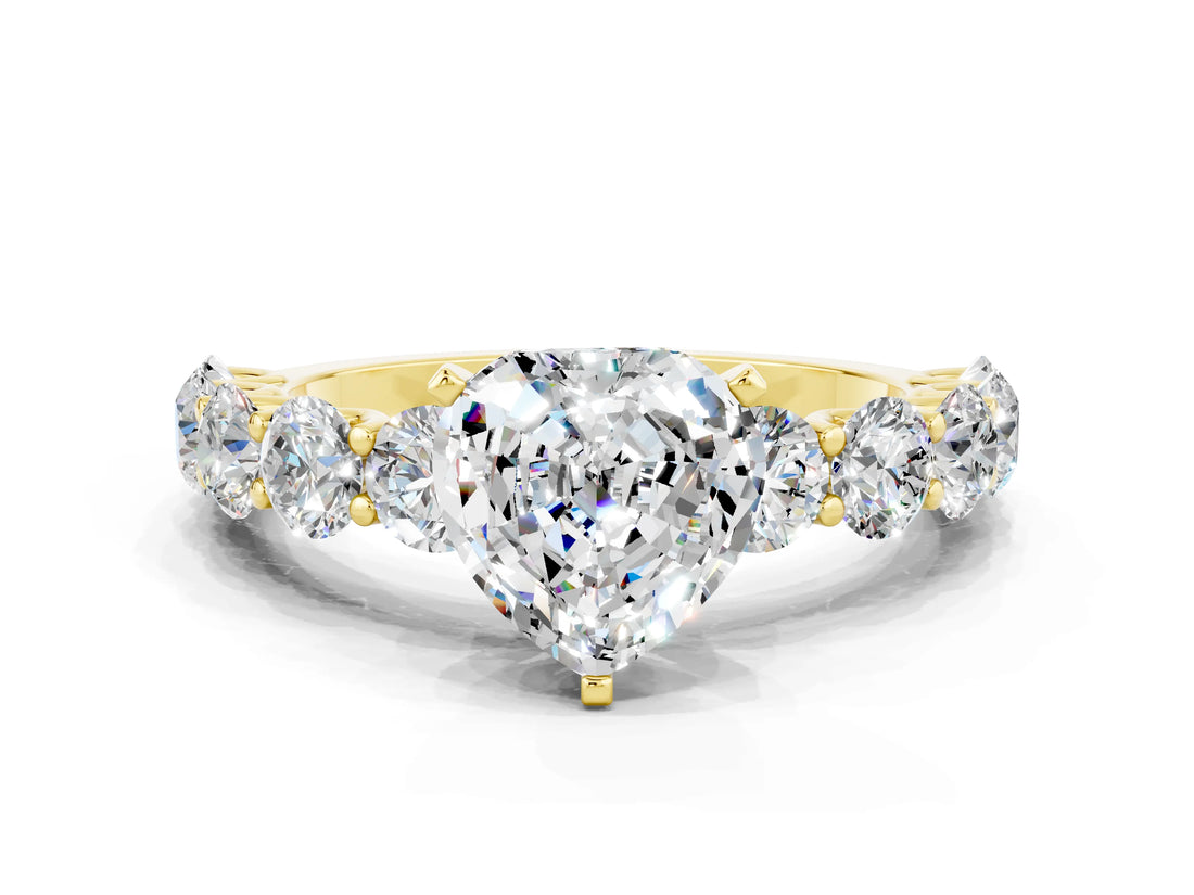 Yellow gold Heart Cut Moissanite Prong Setting with Side Stones on a Pave Band