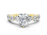 Yellow gold Heart Cut Moissanite Prong Setting with Side Stones on a Pave Band