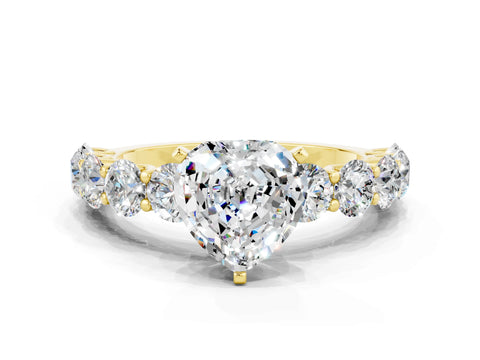 Yellow gold Heart Cut Moissanite Prong Setting with Side Stones on a Pave Band