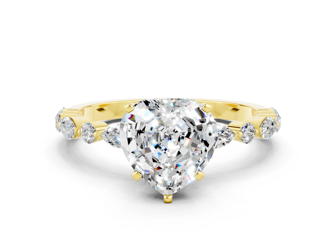 Yellow gold Heart Cut Moissanite Solitaire with Side Stones on a Pavé Band and Four-Prong Setting