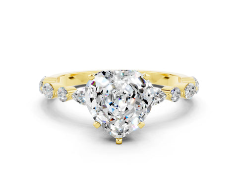 Yellow gold Heart Cut Moissanite Solitaire with Side Stones on a Pavé Band and Four-Prong Setting